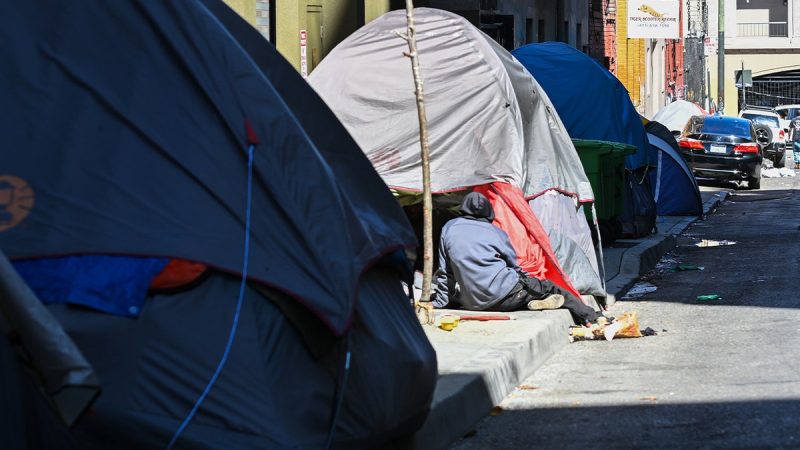The Trump administration is looking to cut funding for a program that provides permanent housing to the homeless, a move that may leave those the program aims to help back on the streets, according to a report.
More than 170,000 people could be at risk of experiencing homelessness when more than half the funding for the Department of Housing and Urban Development’s (HUD) permanent housing program is cut, Politico reported on Monday, citing three HUD employees, internal HUD documents and a person with knowledge of the Continuum of Care (CoC) program.
The cut funds will be moved to transitional housing assistance with some work or service requirements, according to the internal documents and those with knowledge of the situation. The cuts could have a greater impact on rural areas that have less access to city and state funds to supplement federal dollars, the people told the outlet.
‘When the subsidy and the support that goes along with those subsidies is removed, it puts people at grave risk,’ said the person with inside knowledge of the CoC program. ‘And most of these folks without these supports will likely end up back in emergency shelters or back on our nation’s streets.’
HUD Secretary Scott Turner wrote in a  Fox News Digital opinion piecei earlier this month about a ‘paradigm shift’ in the department’s approach to homelessness and housing.
‘But our goal is to let HUD use real, proven effective strategies, and there is no evidence that giving free apartments to the homeless without preconditions or participation requirements – like job training or treatment – leads to good outcomes,’ Turner wrote. 
‘There is<i> </i>evidence, however, that countless lives have been lost to overdoses in HUD-funded housing because of this failed ideology,’ the secretary continued.
Turner wrote that HUD wants to continue to help support work that aims to aid those experiencing homelessness and battling addiction to recover and become self-sufficient.
Permanent housing funding for 2026 is currently $3.3 billion and could be cut in half to $1.1 billion through the Trump administration’s effort, according to Politico. 
This post appeared first on FOX NEWS Trump admin targets $3.3B homeless housing program, 170,000 people could face return to streets: report